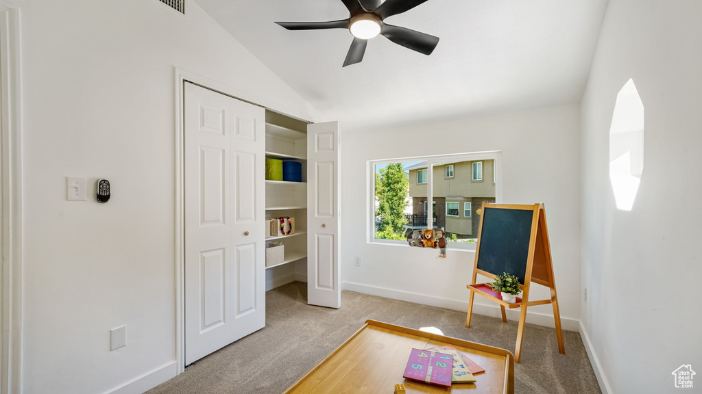 Sitting room featuring carpet, vaulted ceiling, and ceiling fan
