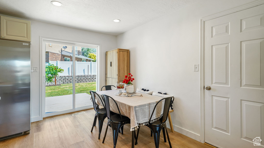 Dining room featuring light wood-style floors and recessed lighting