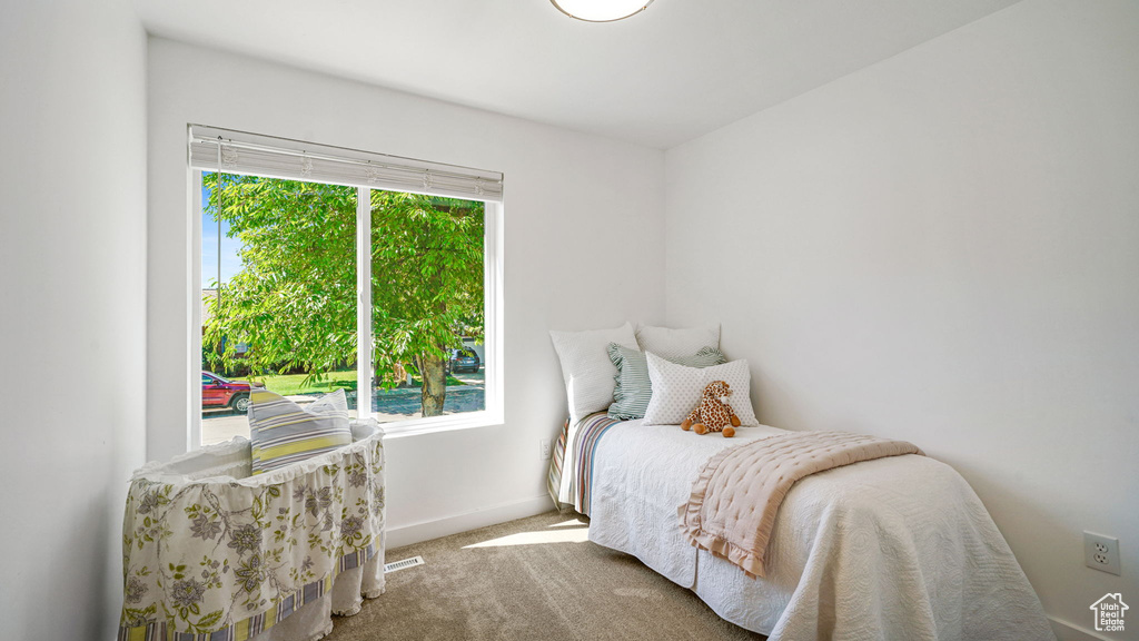 Bedroom featuring baseboards and carpet