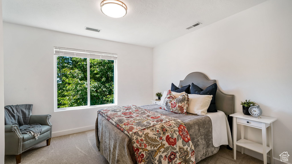 Bedroom featuring carpet and baseboards