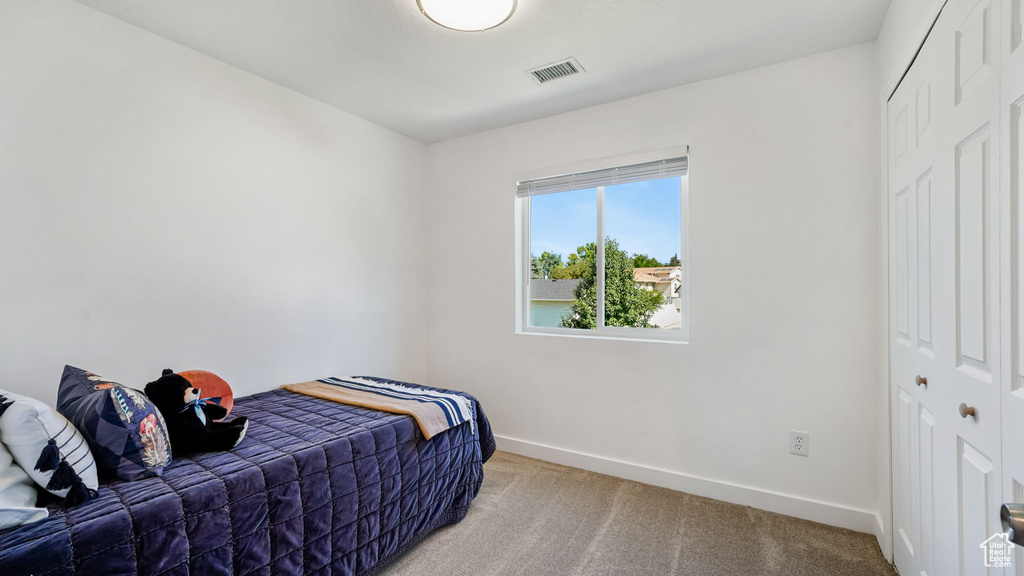 Bedroom featuring carpet floors and a closet