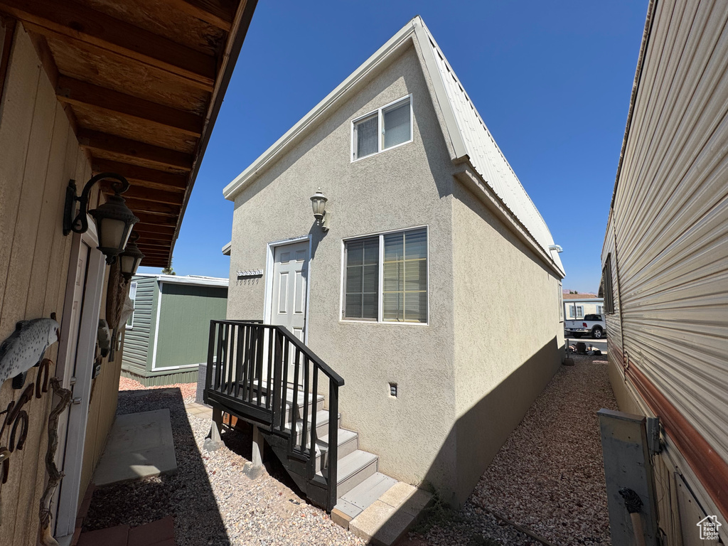 Rear view of house featuring stucco siding