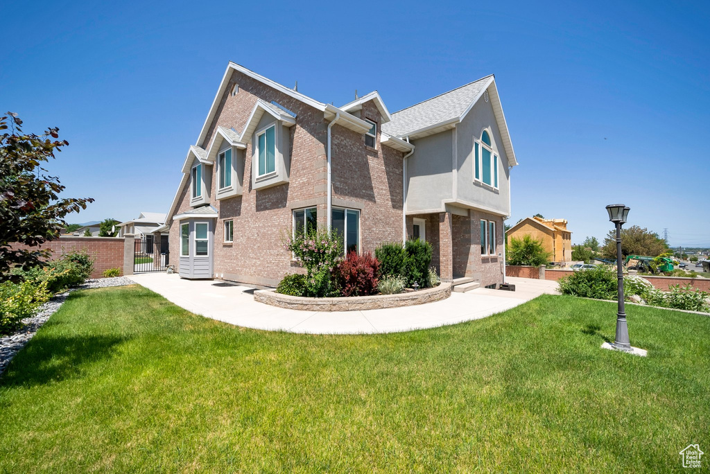 Rear view of property featuring brick siding