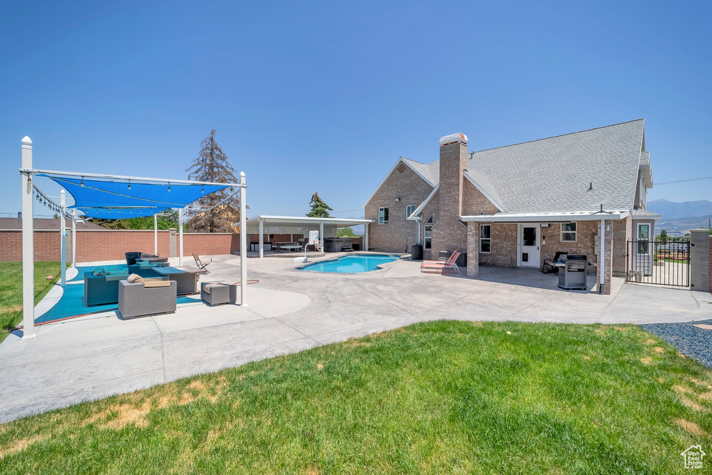 View of swimming pool featuring an outdoor hangout area, a fenced backyard, a patio, and a grill