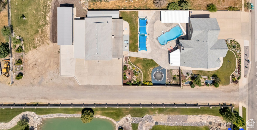 Aerial view of a pool and a large body of water