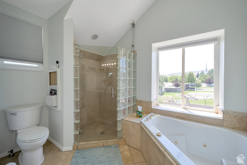 Bathroom featuring a stall shower, a whirlpool tub, tile patterned flooring, and lofted ceiling
