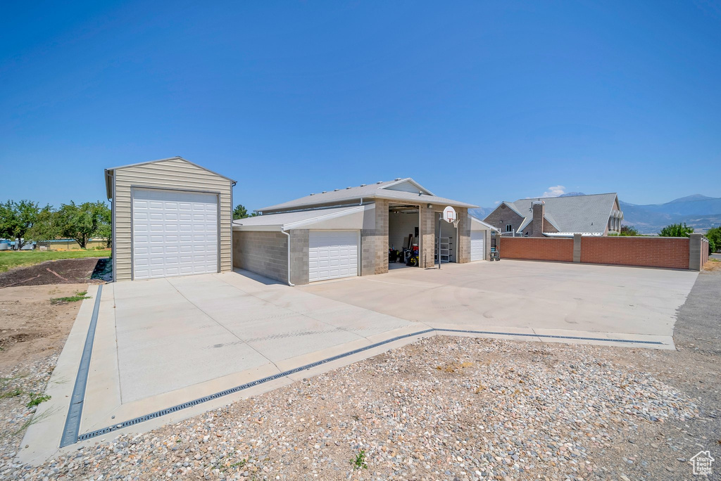 Detached garage featuring a mountain view and a storage unit