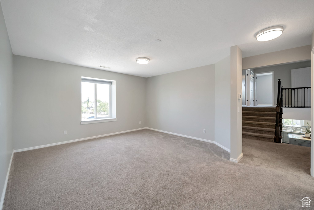 Spare room with carpet flooring and stairs