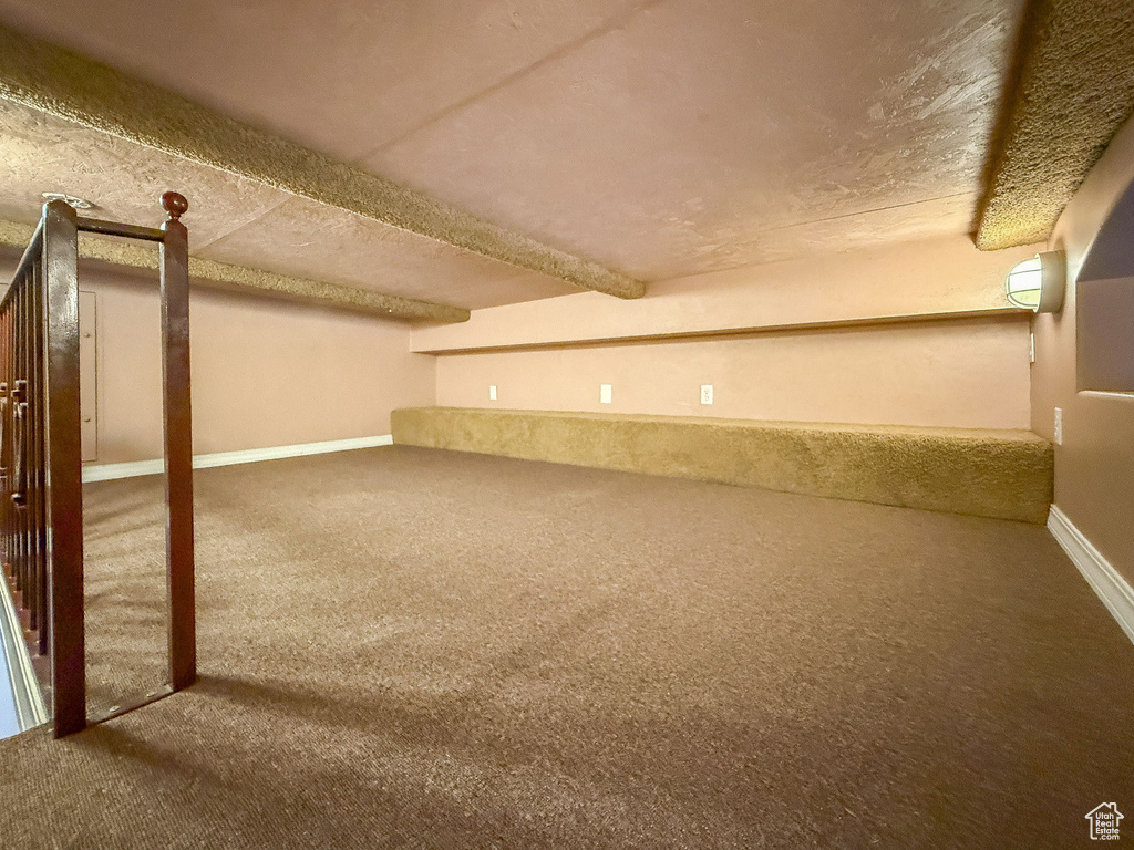 Finished below grade area featuring carpet and a textured ceiling