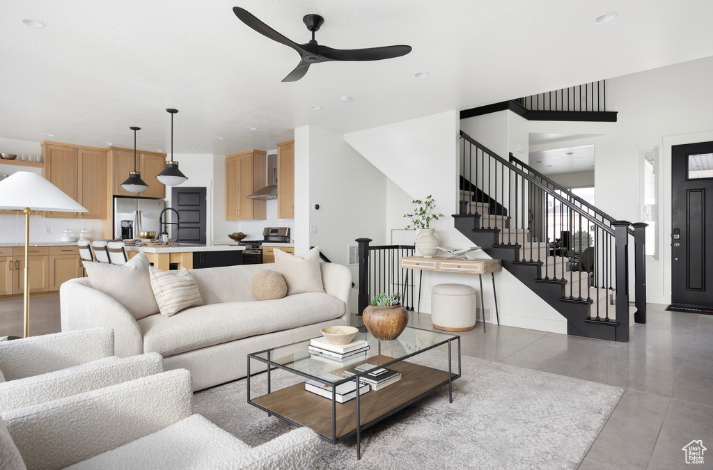 Living room featuring ceiling fan, stairs, and recessed lighting