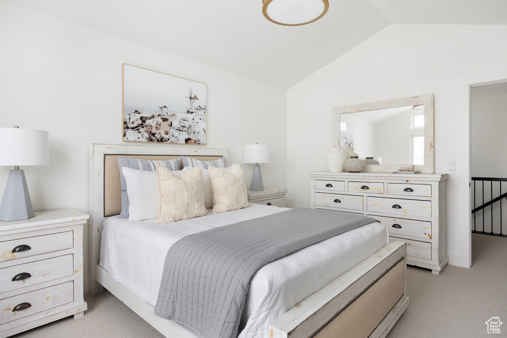 Bedroom featuring light colored carpet and lofted ceiling