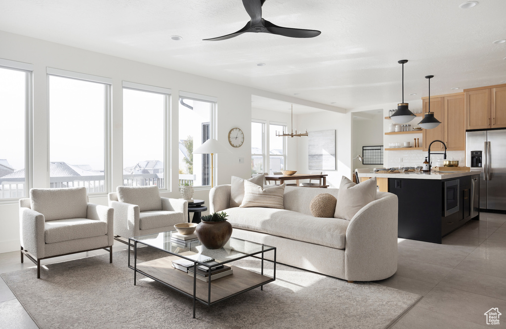 Living area with plenty of natural light, ceiling fan, a chandelier, and recessed lighting