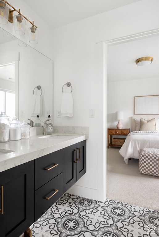 Ensuite bathroom with double vanity and tile patterned floors