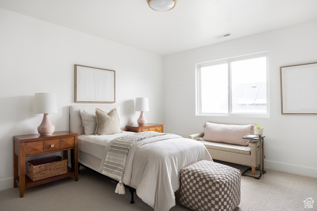 Bedroom featuring light colored carpet and baseboards