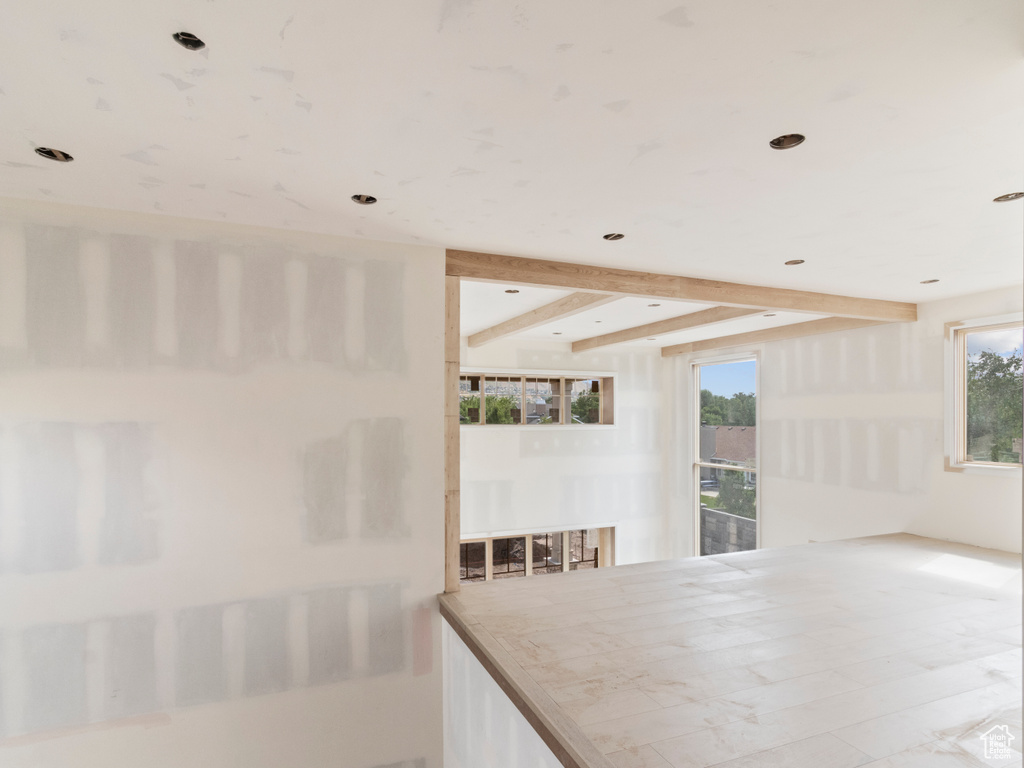 Dining room with beamed ceiling, plenty of natural light, and recessed lighting