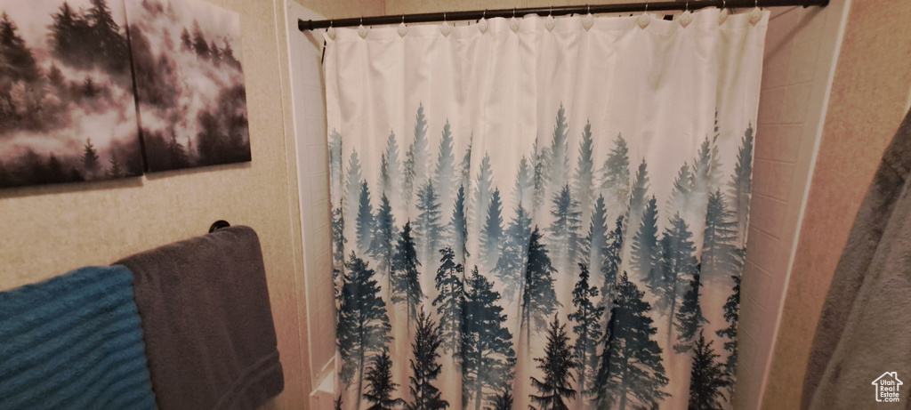 Bathroom with curtained shower