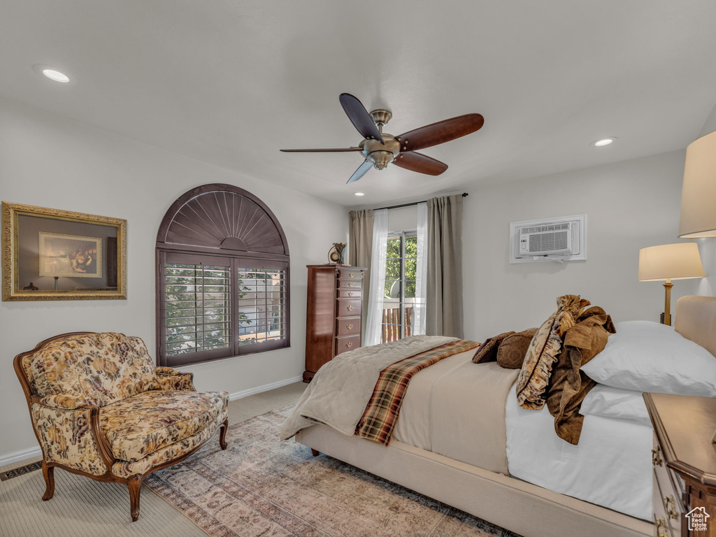Carpeted bedroom featuring a wall unit AC, recessed lighting, and a ceiling fan