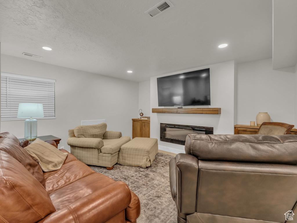 Living area with recessed lighting and a fireplace