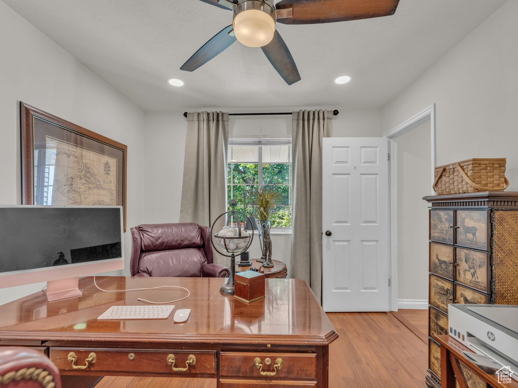 Home office with a ceiling fan, light wood-type flooring, and recessed lighting