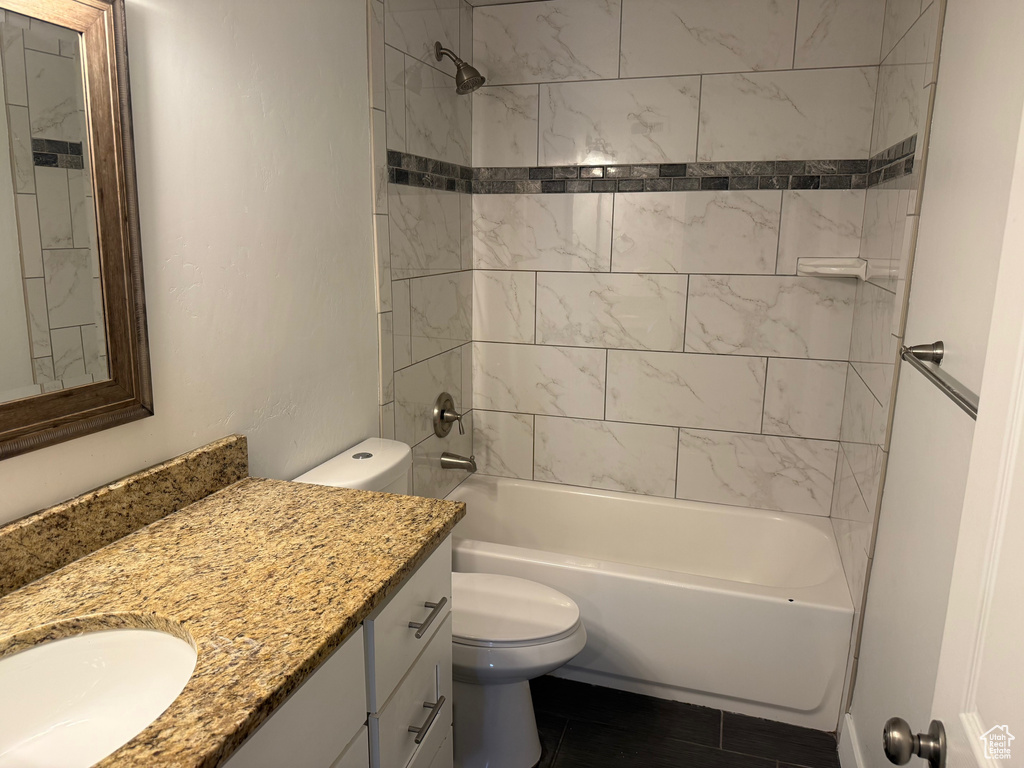 Full bath featuring vanity and washtub / shower combination