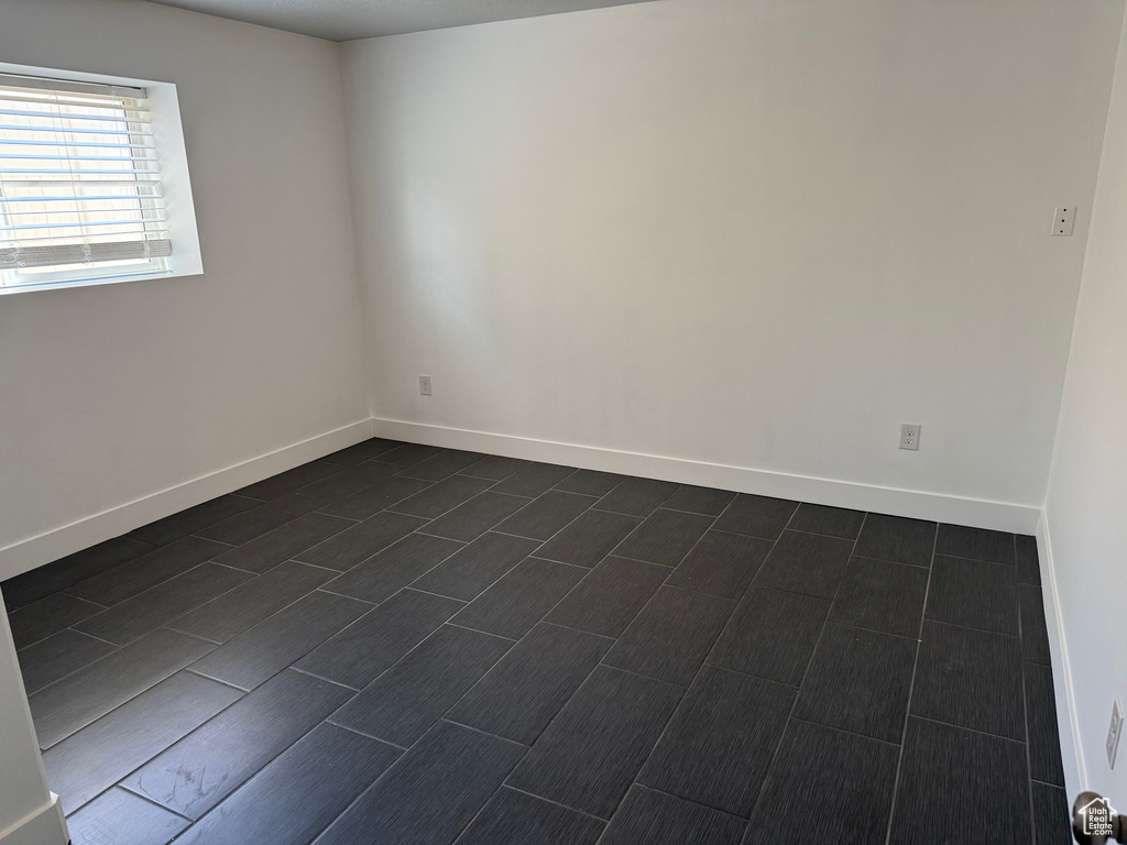 Spare room featuring baseboards