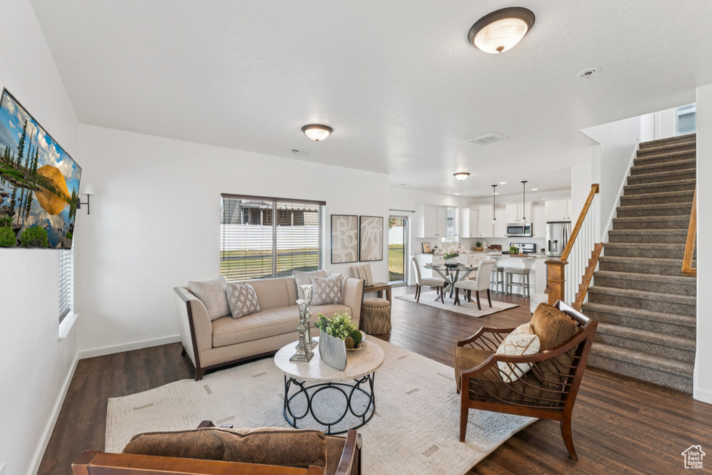 Living area featuring stairway and wood finished floors
