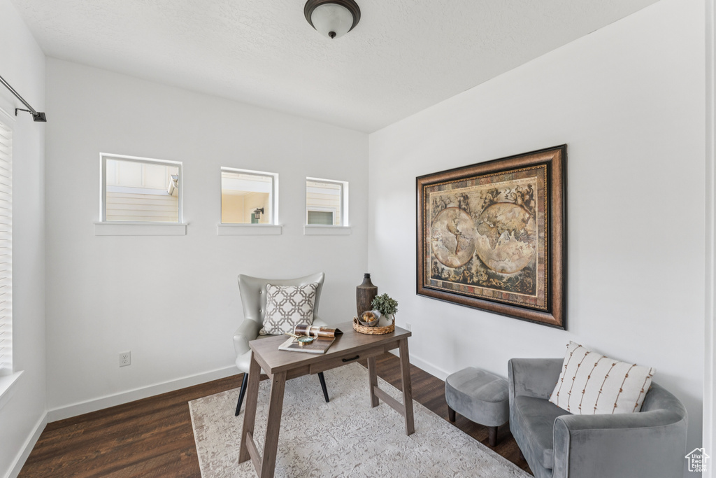 Home office featuring dark wood-style floors and baseboards