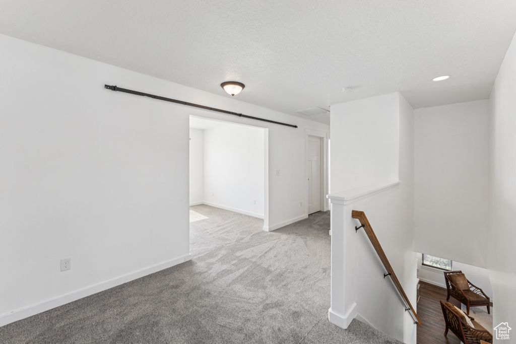 Carpeted empty room featuring baseboards