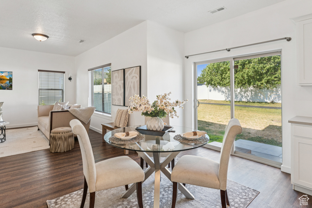 Dining space with wood finished floors and baseboards