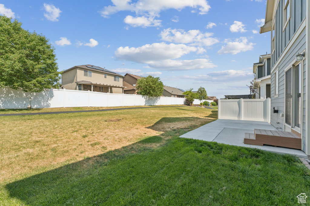 View of yard with a patio area and a residential view