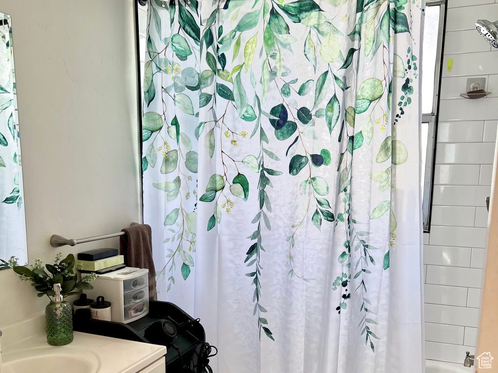 Bathroom with vanity and shower / bath combination with curtain