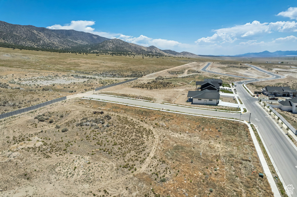 Aerial view of sparsely populated area with mountains and a desert landscape