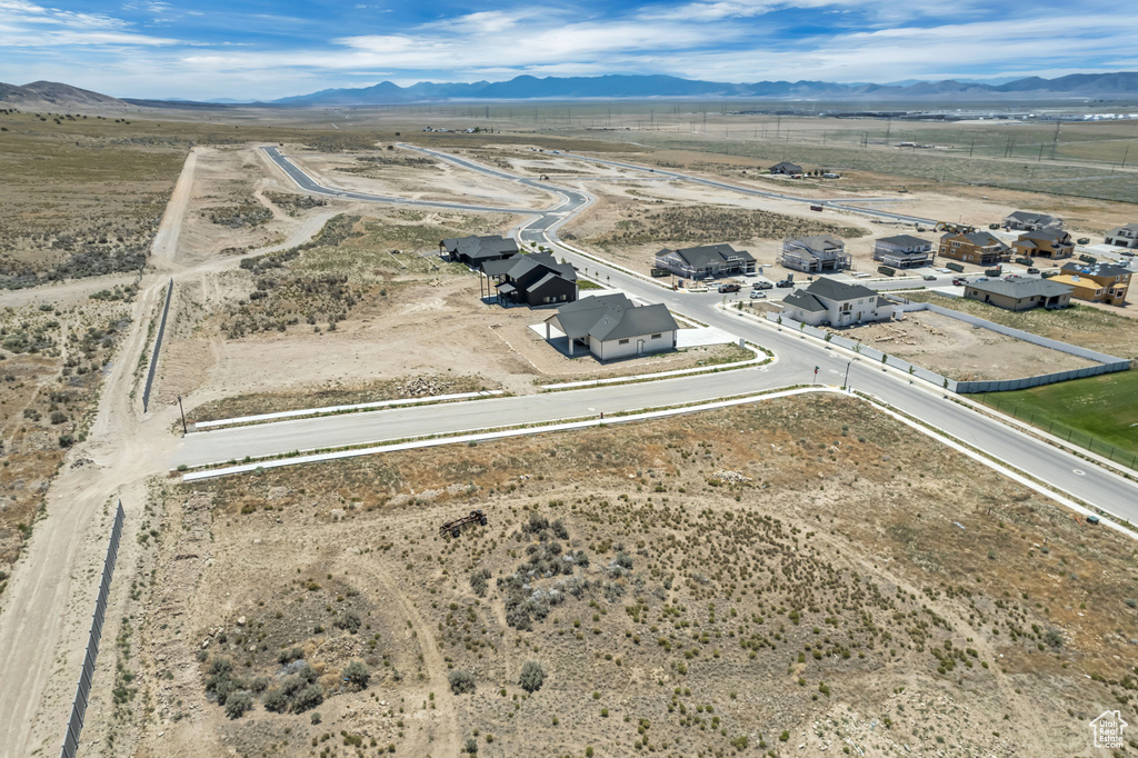 Aerial view of sparsely populated area with a mountain backdrop