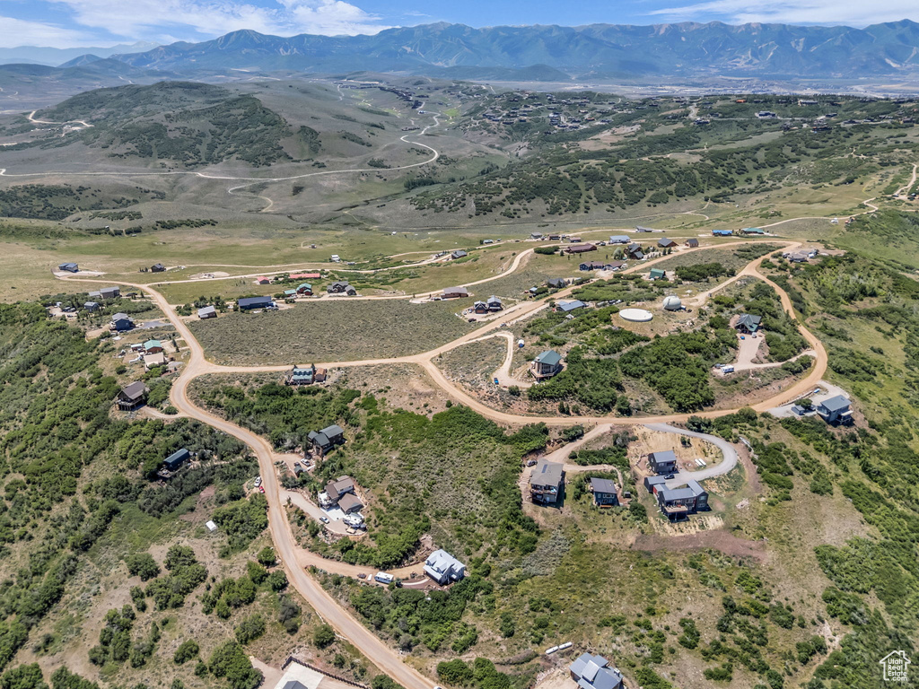 Aerial view of property and surrounding area with a mountain backdrop and rural landscape