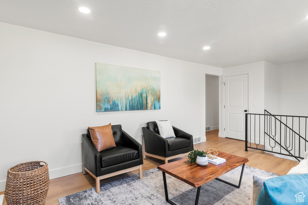 Living area featuring light wood-style flooring and recessed lighting