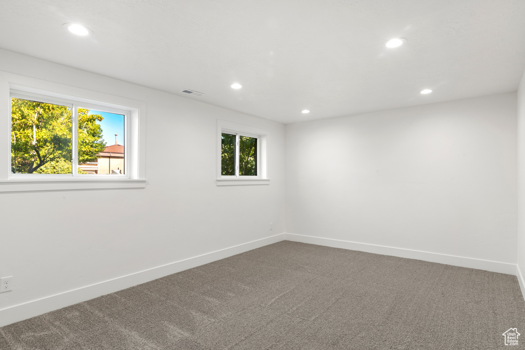 Empty room featuring recessed lighting and carpet