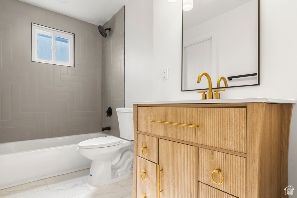 Full bath featuring bathtub / shower combination, vanity, and marble finish floors