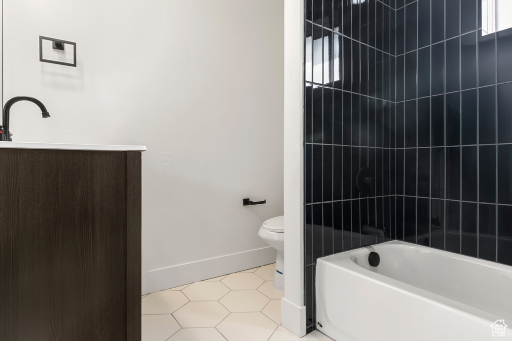 Full bathroom featuring  shower combination, vanity, and tile patterned flooring