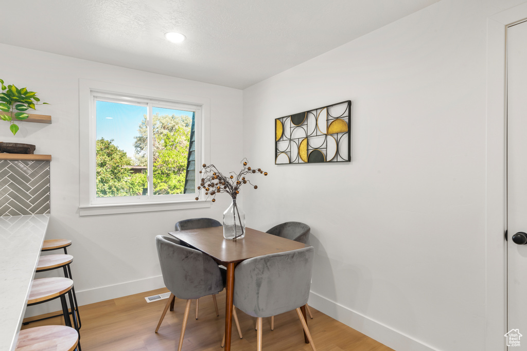 Dining space featuring light wood finished floors and recessed lighting