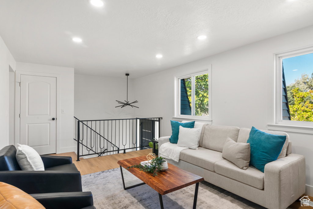 Living area featuring light wood-style floors and recessed lighting