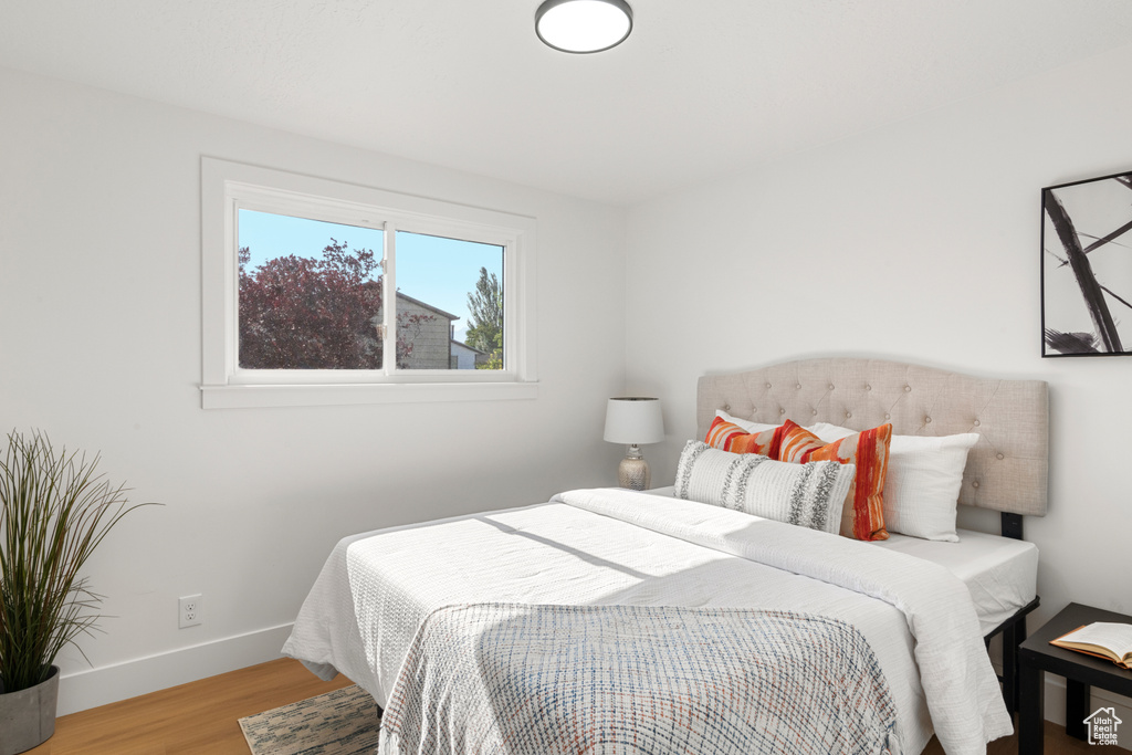 Bedroom featuring wood finished floors and baseboards