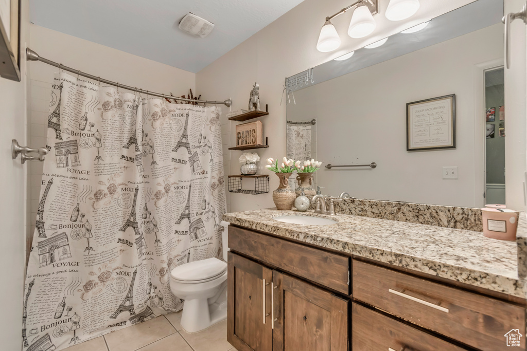 Bathroom with vanity, tile patterned flooring, and curtained shower
