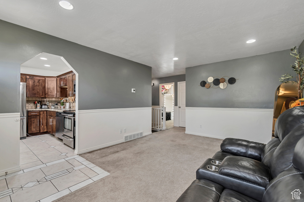 Living area featuring recessed lighting and light tile patterned floors