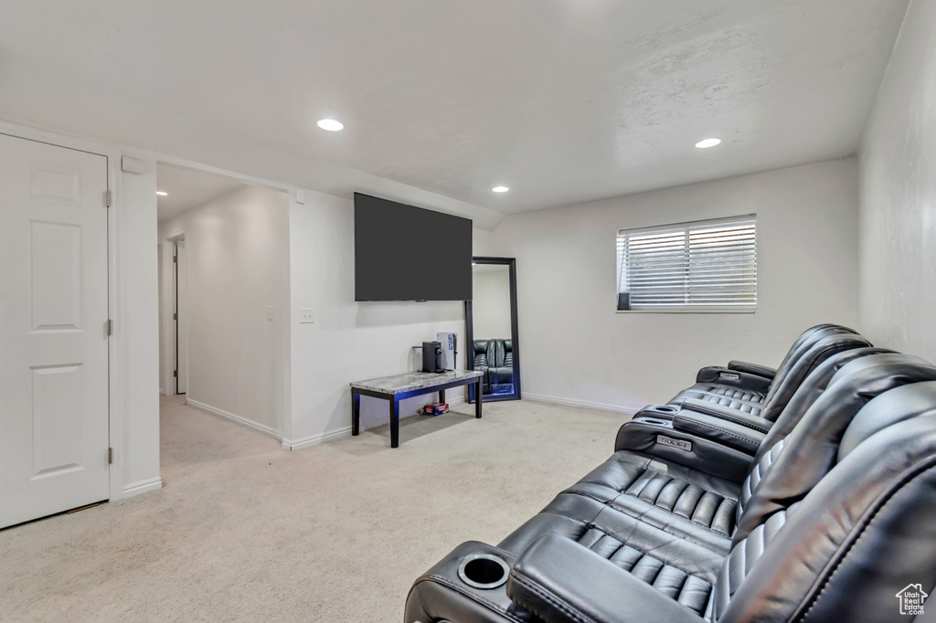 Living area featuring light colored carpet and recessed lighting