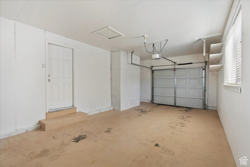 Garage featuring a garage door opener