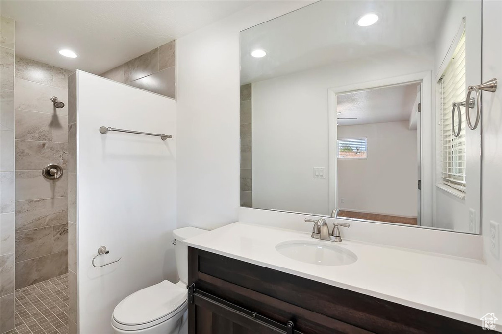 Bathroom with vanity, a walk in shower, and recessed lighting