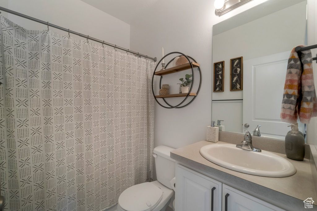 Bathroom featuring vanity and curtained shower