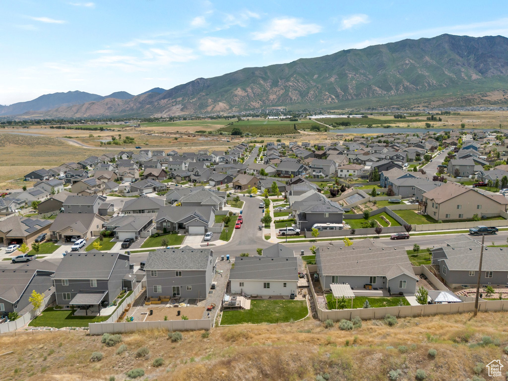 Aerial overview of property\\\'s location featuring a mountainous background and nearby suburban area