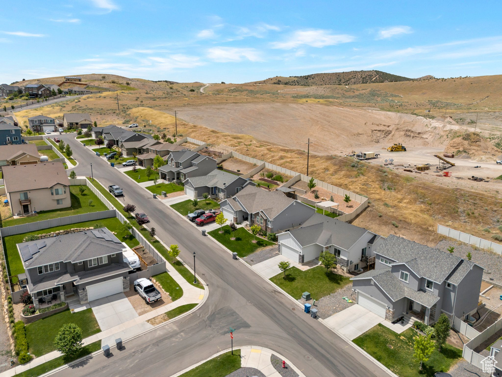 Aerial overview of property\\\'s location featuring nearby suburban area and a mountain backdrop