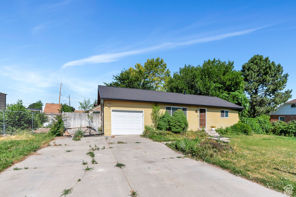 View of front of property with driveway and a garage